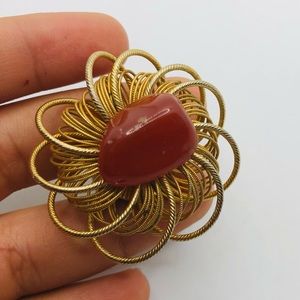 Unique gold colored ring orange rock on top